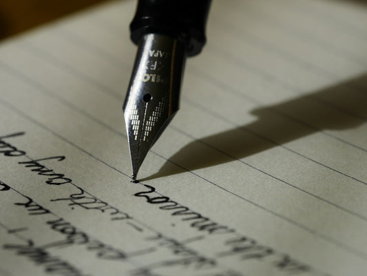 A pen resting on an open notebook